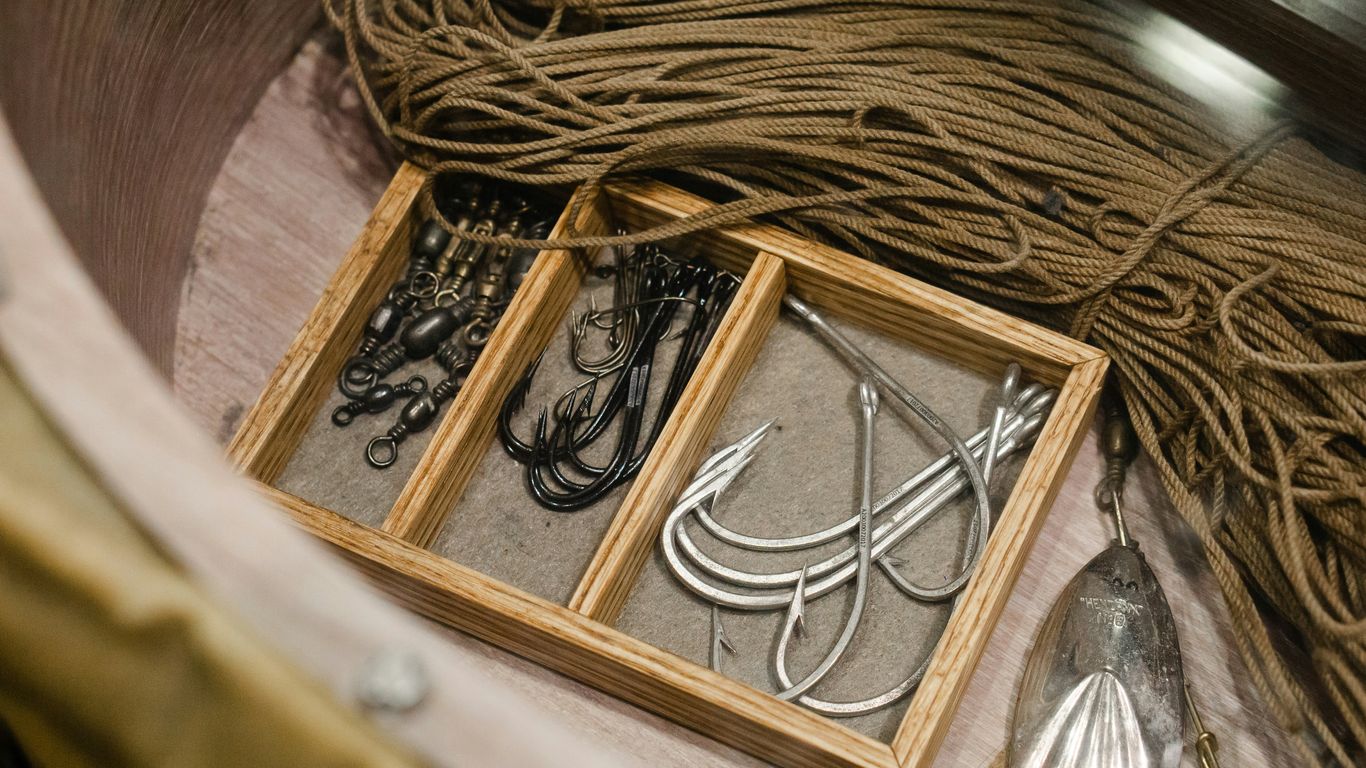 Fishing hooks arranged beside tackle boxes