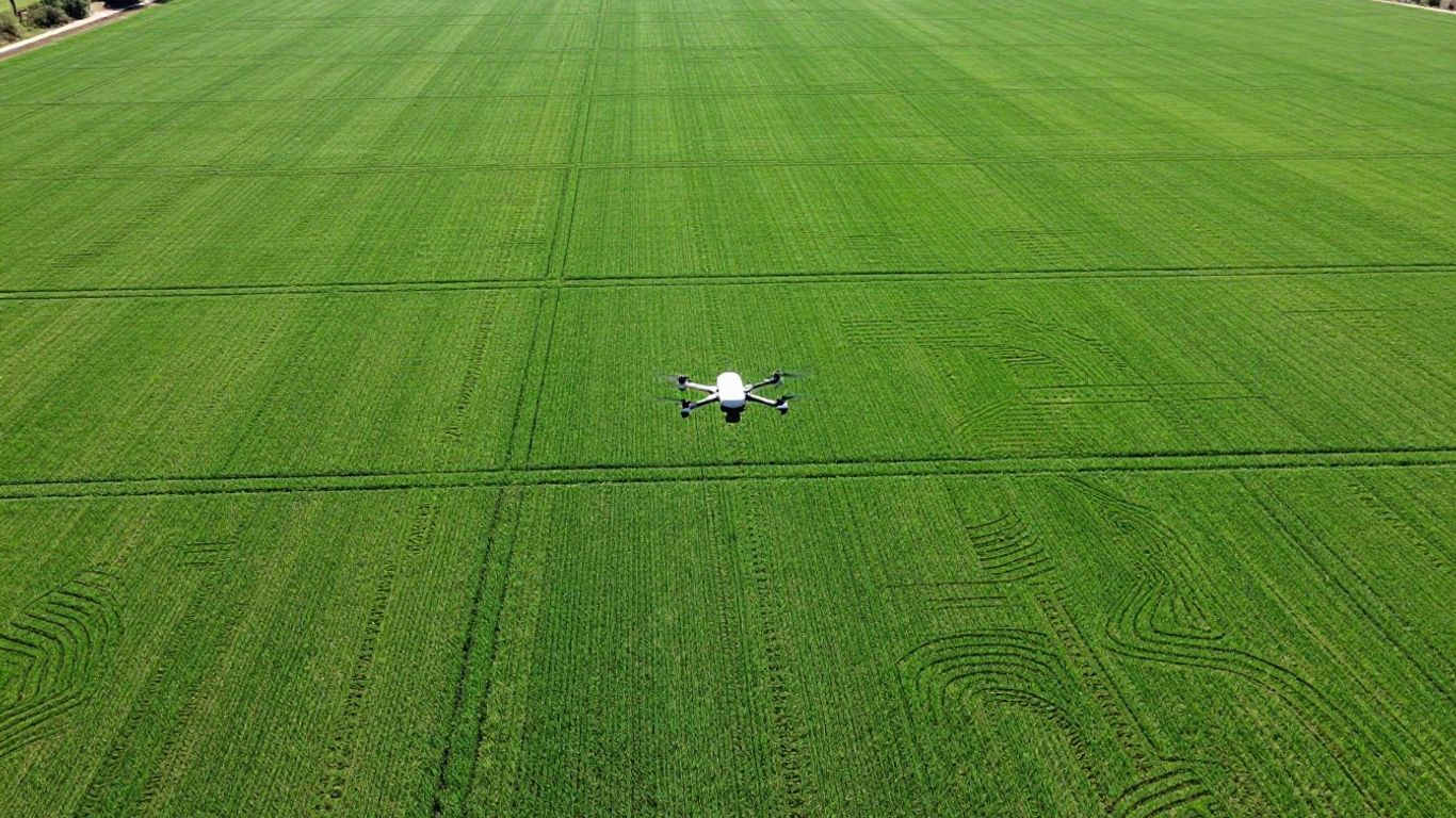 Drone surveying a precisely leveled field with contour lines.