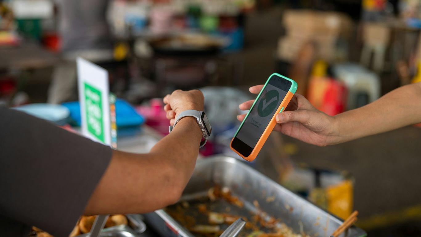 a person handing another person a cell phone