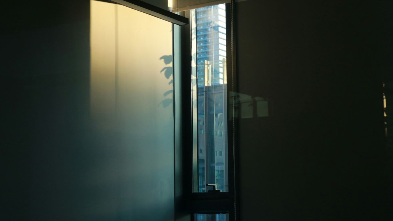 a window with a reflection of a building in it