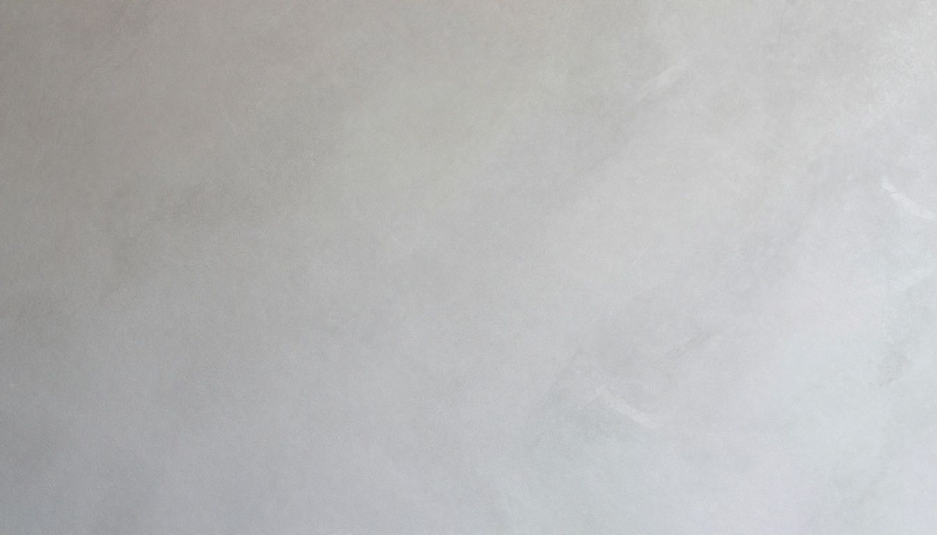 A close-up of a polished Venetian plaster wall with subtle grey tones and a marble-like texture.