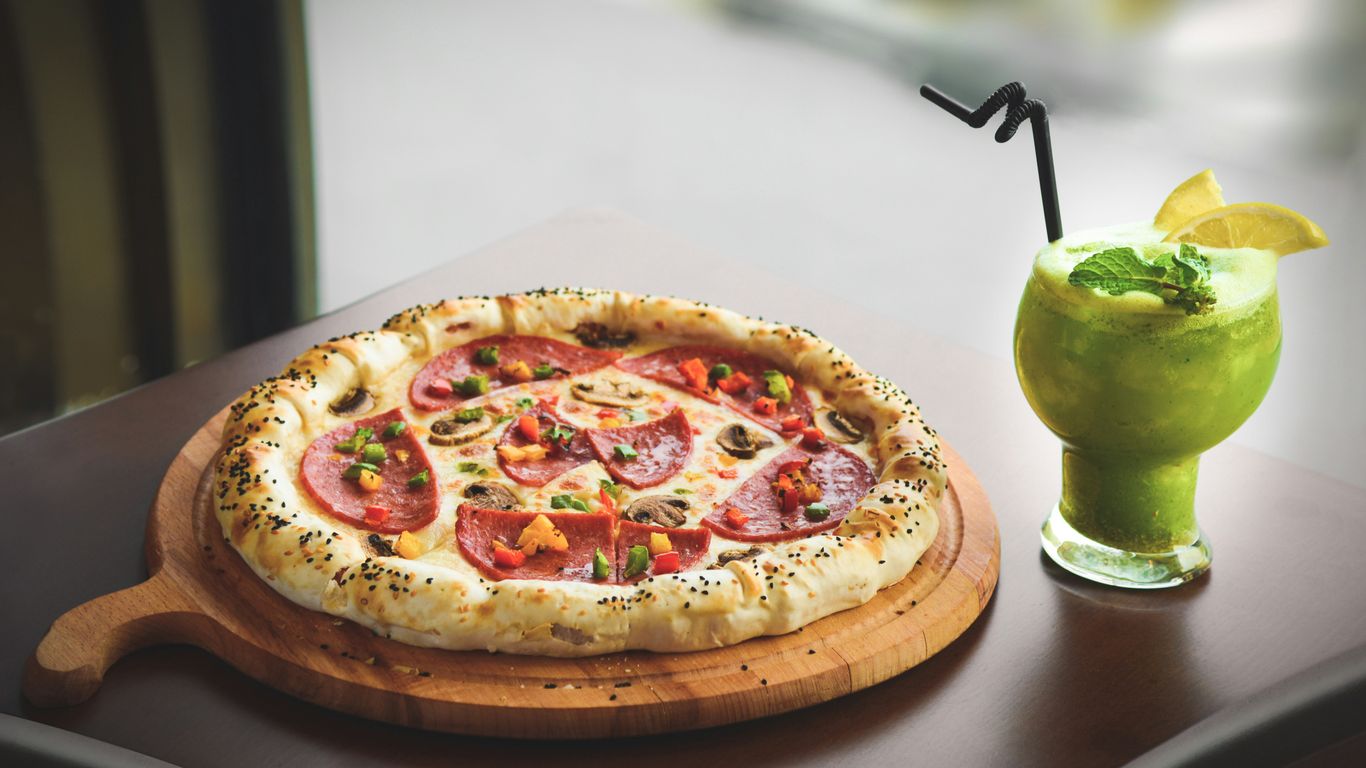a pizza with a lime wedge