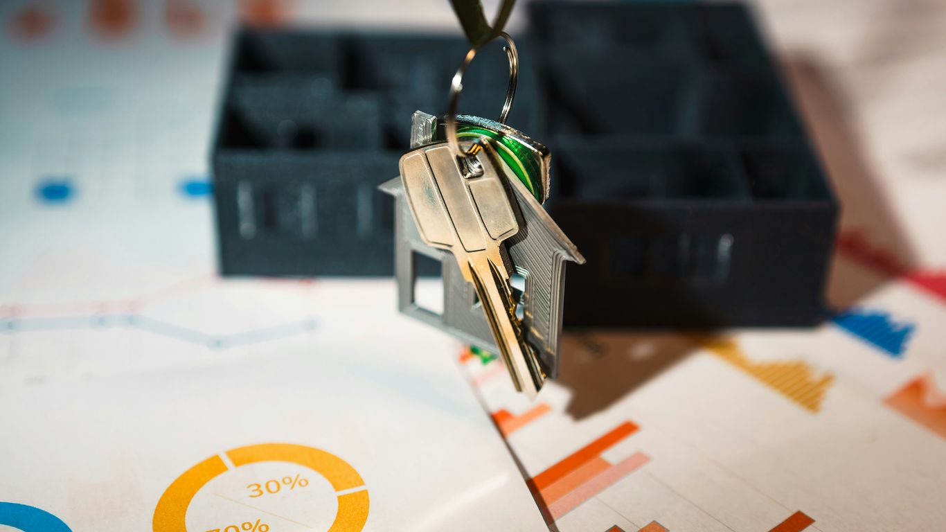 A house shaped keychain hanging from a key chain