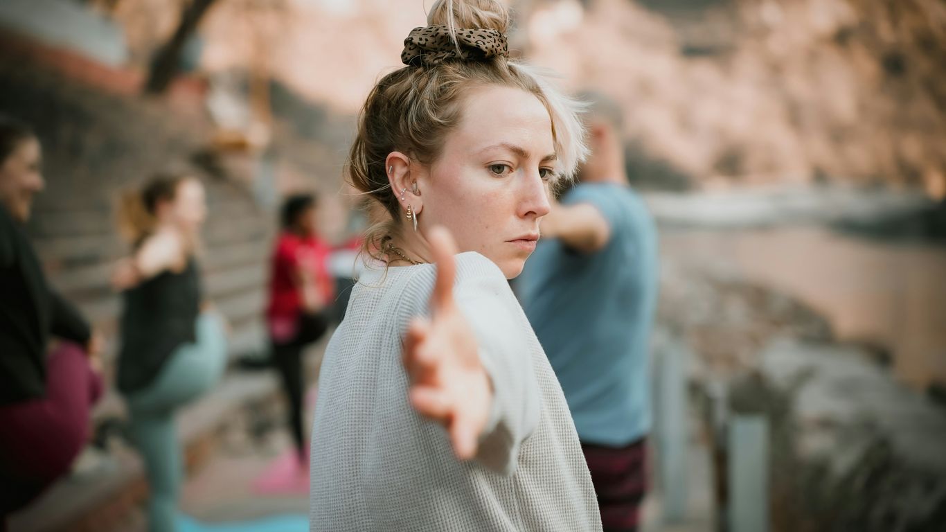 a woman pointing at something while others look on