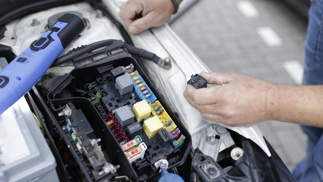 A technician inspecting connected car technology