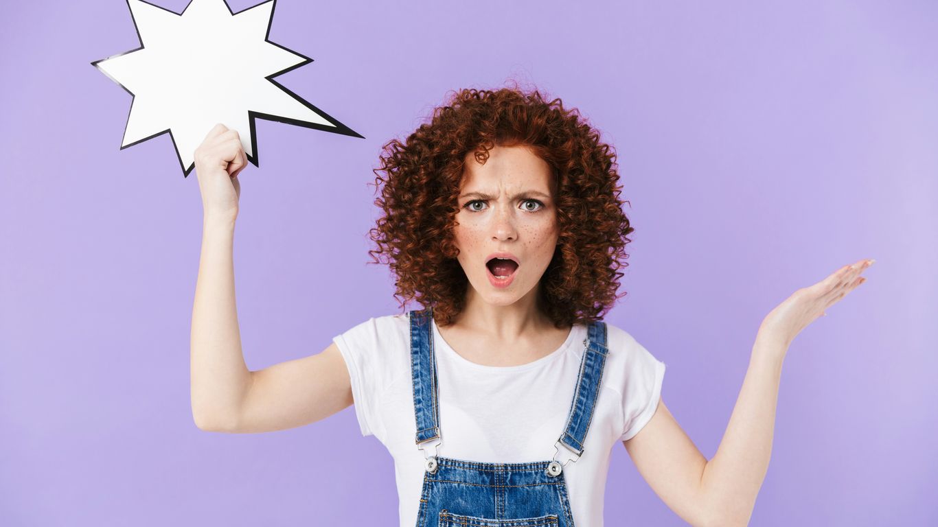 a woman with curly hair holding a speech bubble