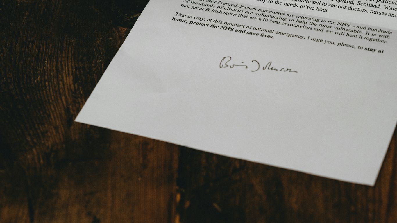 white printer paper on brown wooden table