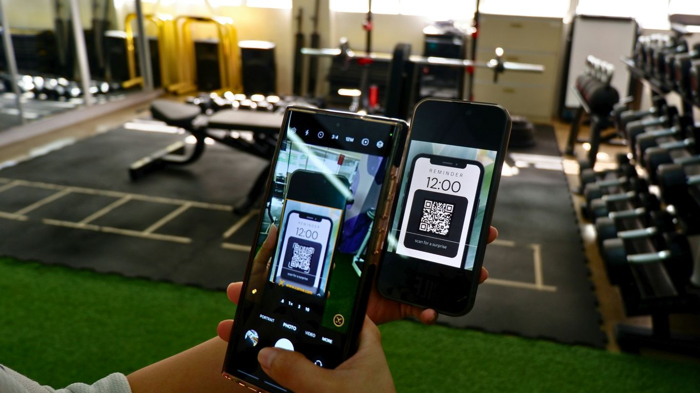 a person holding two cell phones in their hands