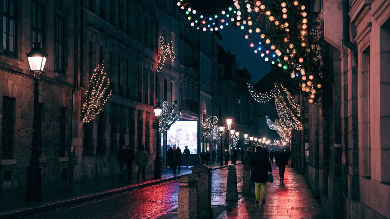 Visitors walking beneath colorful festival lights