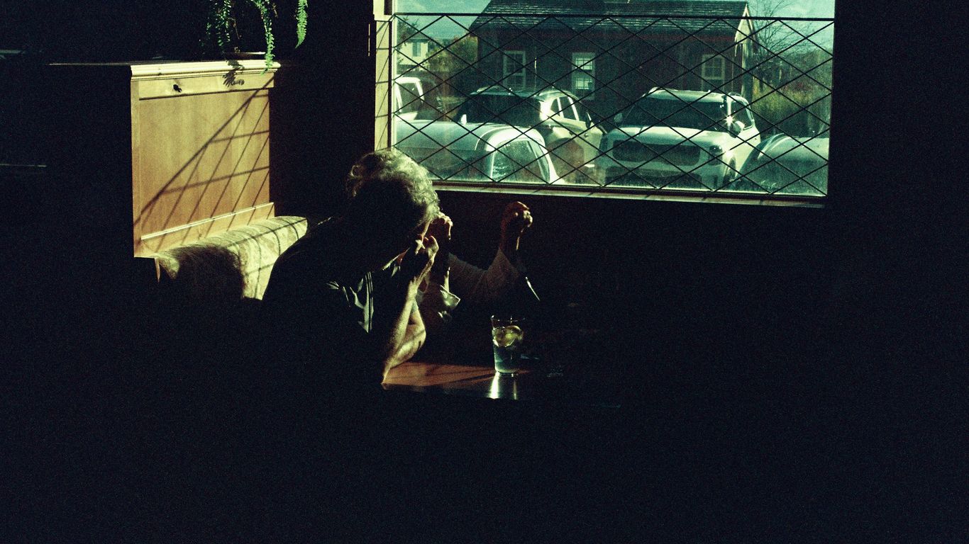 Man sitting by window with drink