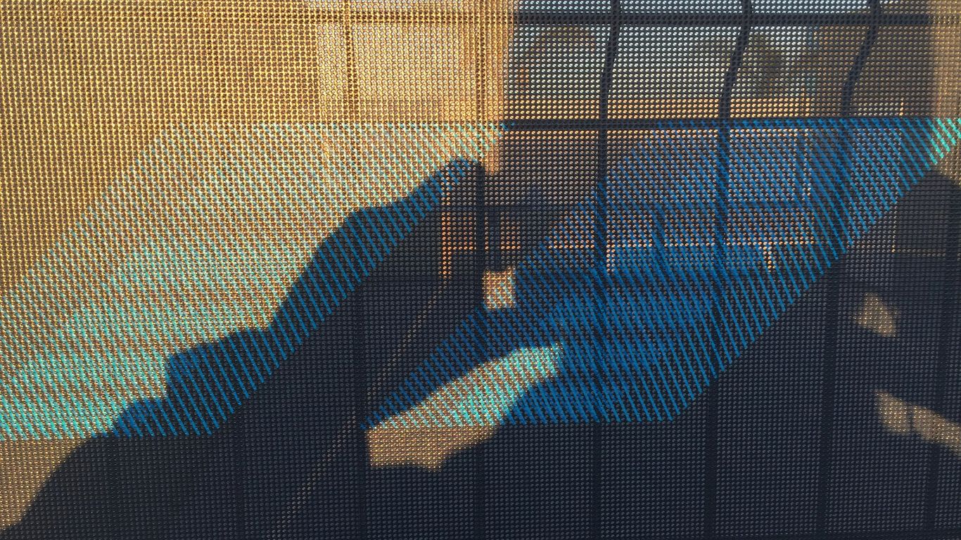 a shadow of a person sitting in a chair