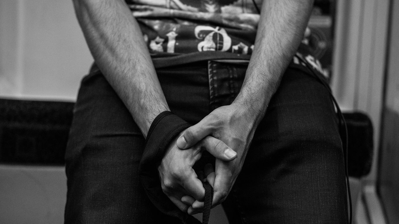 grayscale photo of man and woman holding hands