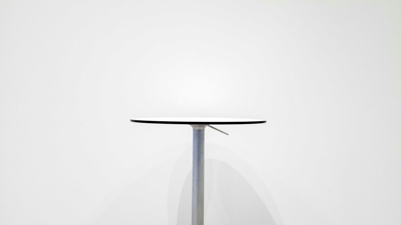 Travertine dining table with sculptural pedestal