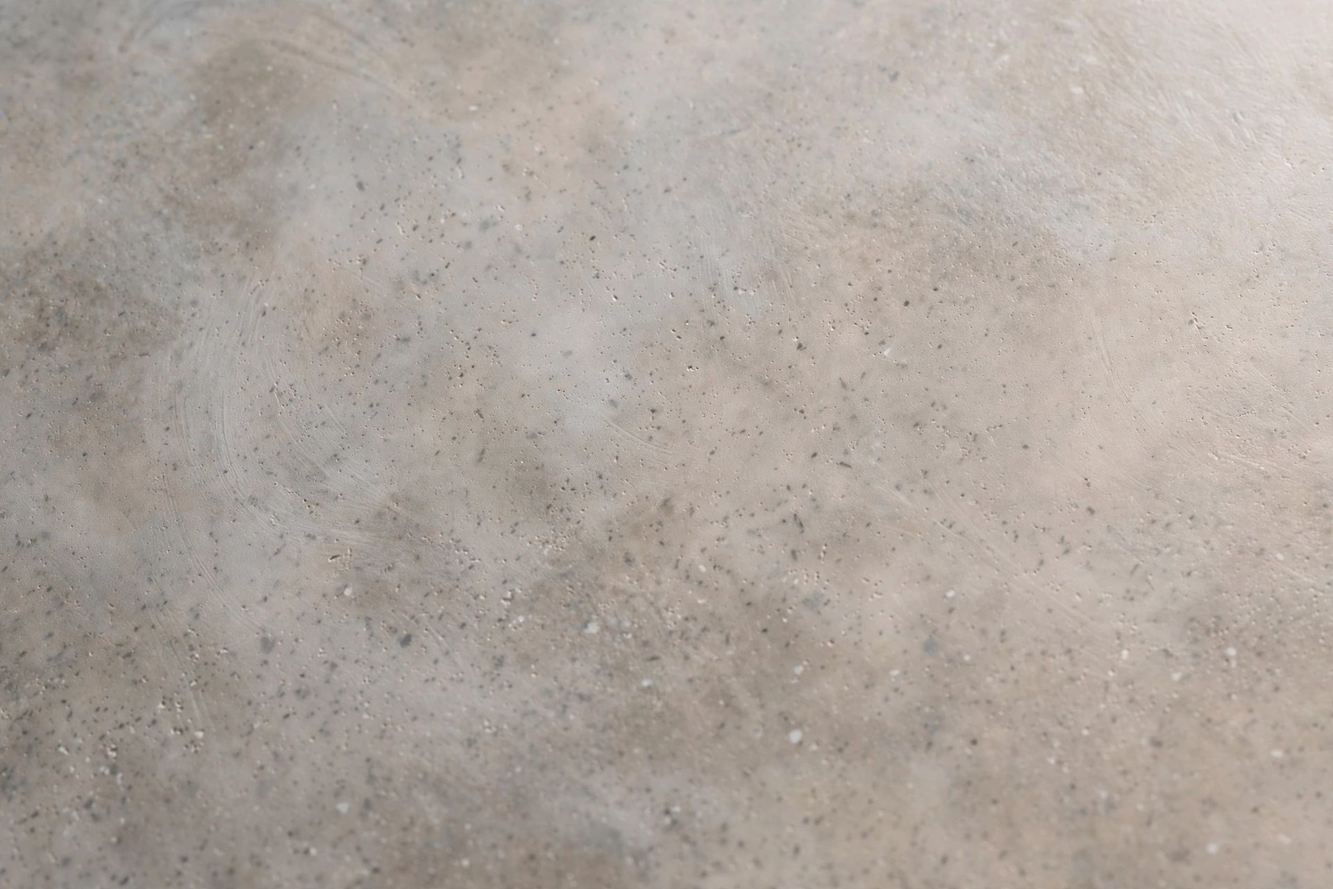 Close-up of a smooth, softly polished microcement surface showing subtle texture and tonal variation