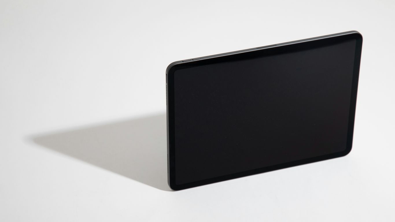 black tablet computer on white table