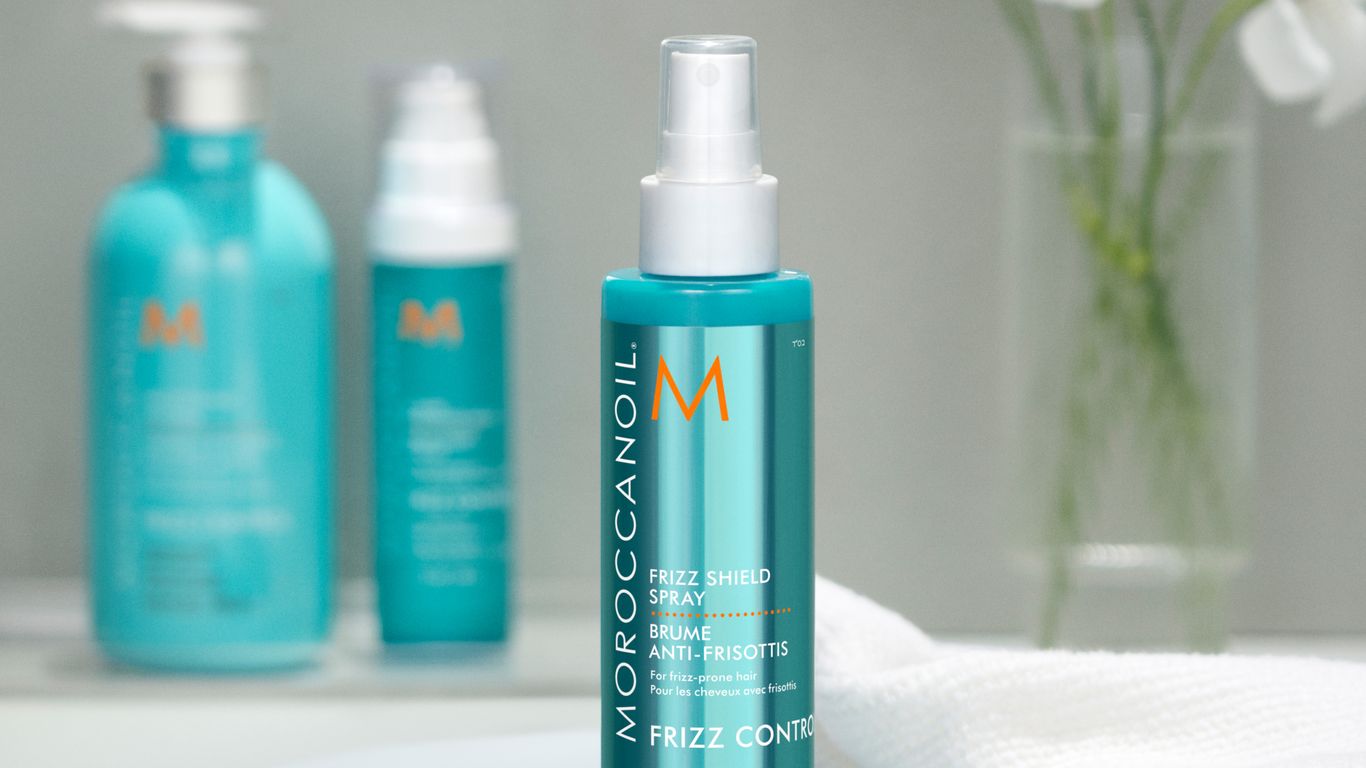 Bathroom setting with Moroccanoil hair products and orchid decoration.