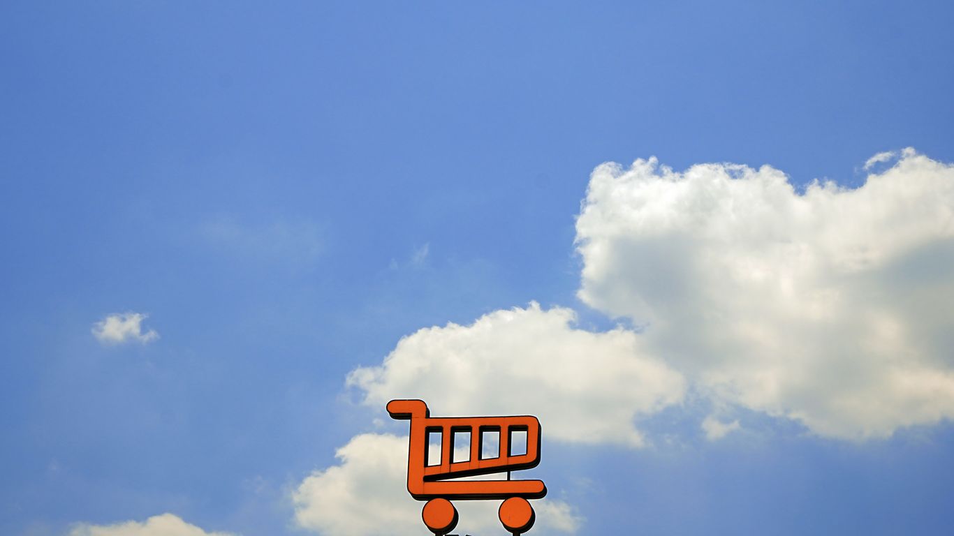 Orange shopping cart against a blue sky