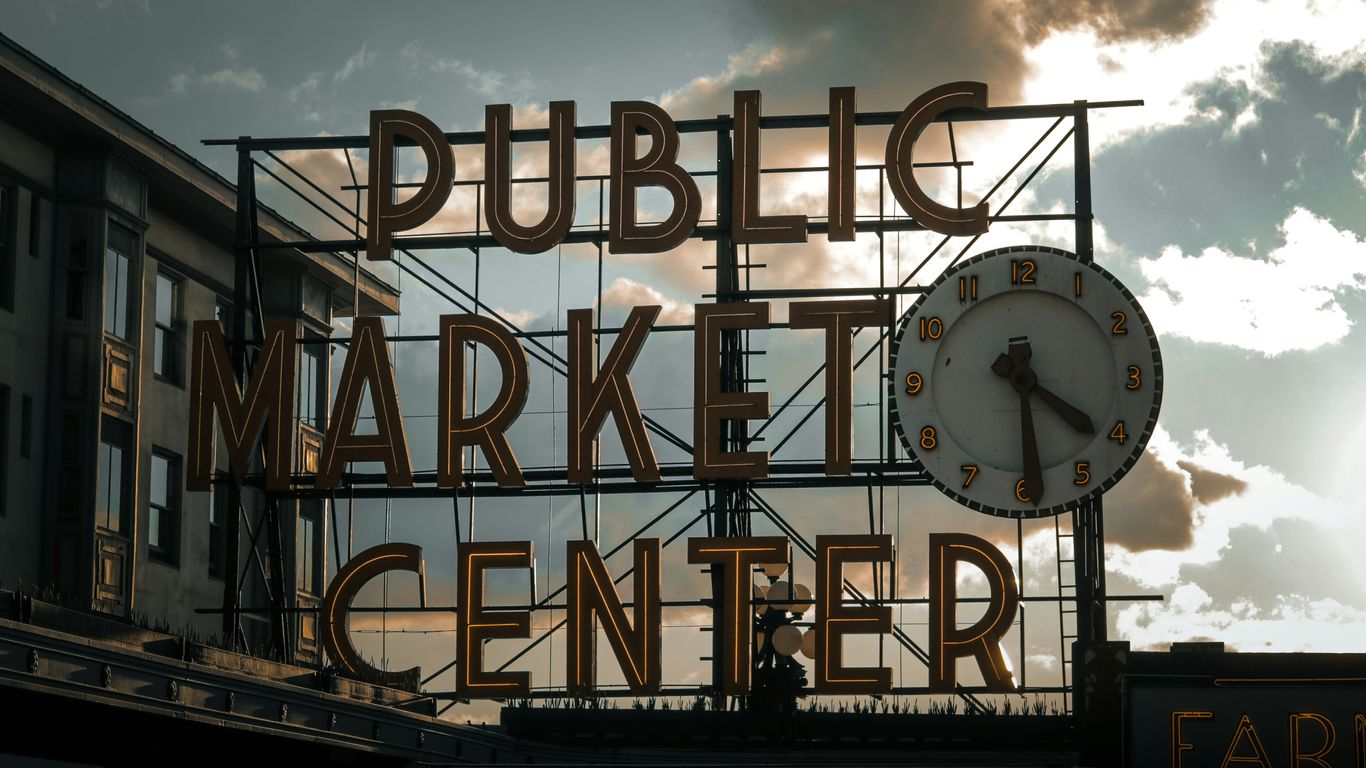 a large sign with a clock on top of it
