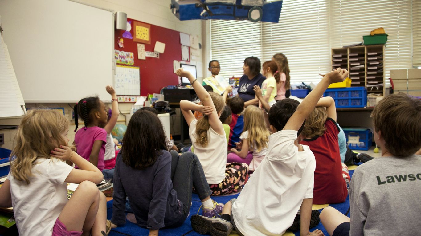Teacher guiding students through a video activity
