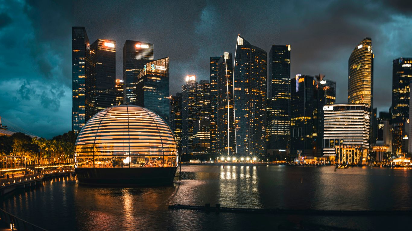 a city skyline at night with lights reflecting in the water