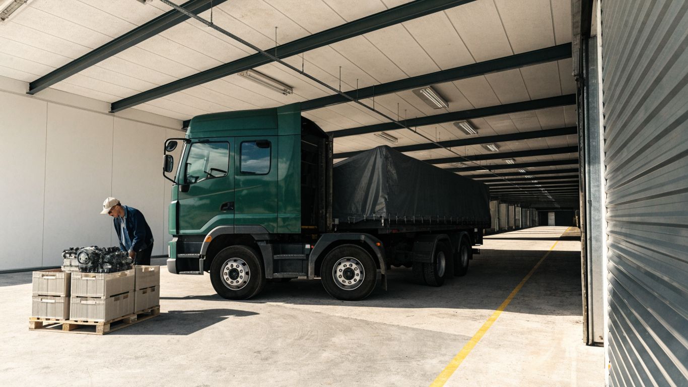 Freight truck beside a securely crated engine