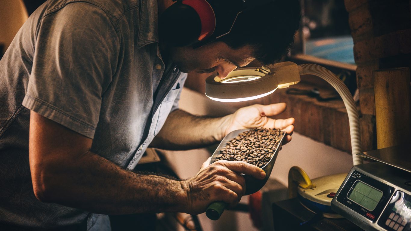 Craftsperson inspecting a marble tabletop
