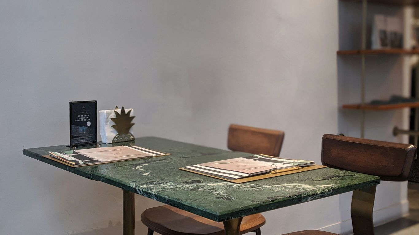Deep green marble dining table in sunlight