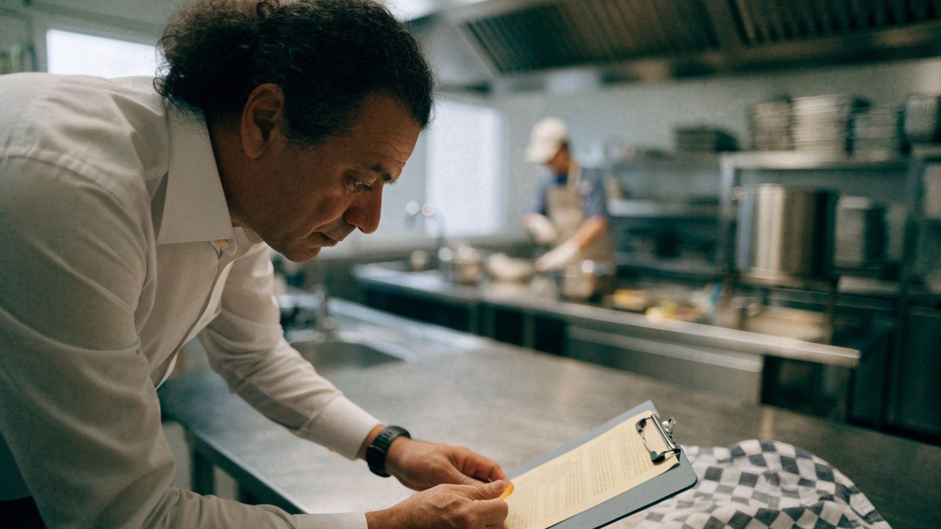 Food safety inspector reviewing a kitchen checklist