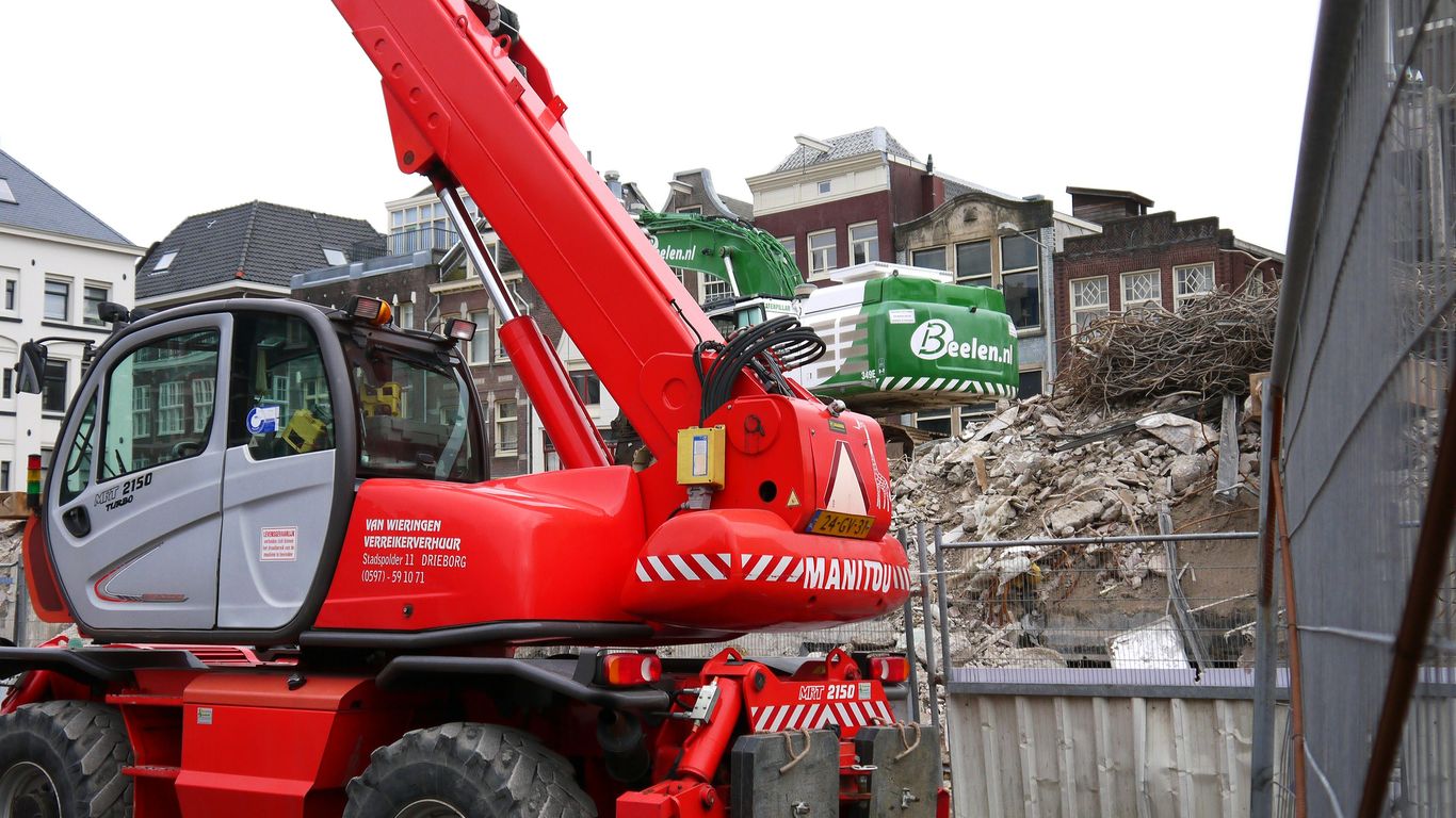 a red crane is parked on the side of the road