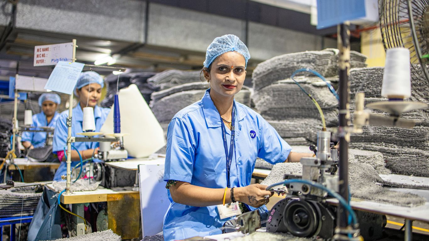 Factory worker assembling makeup brushes