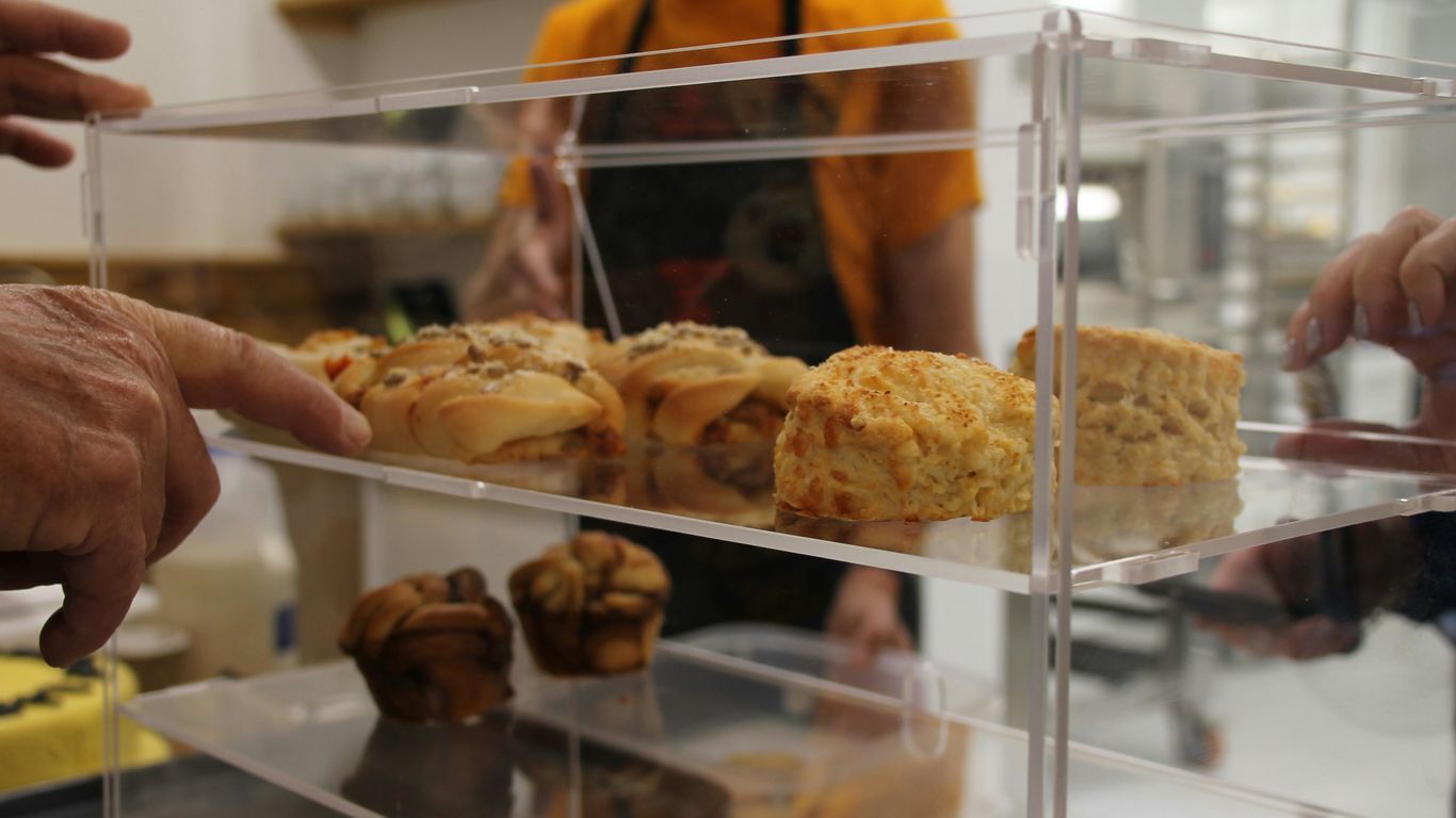 a display case filled with pastries in a bakery