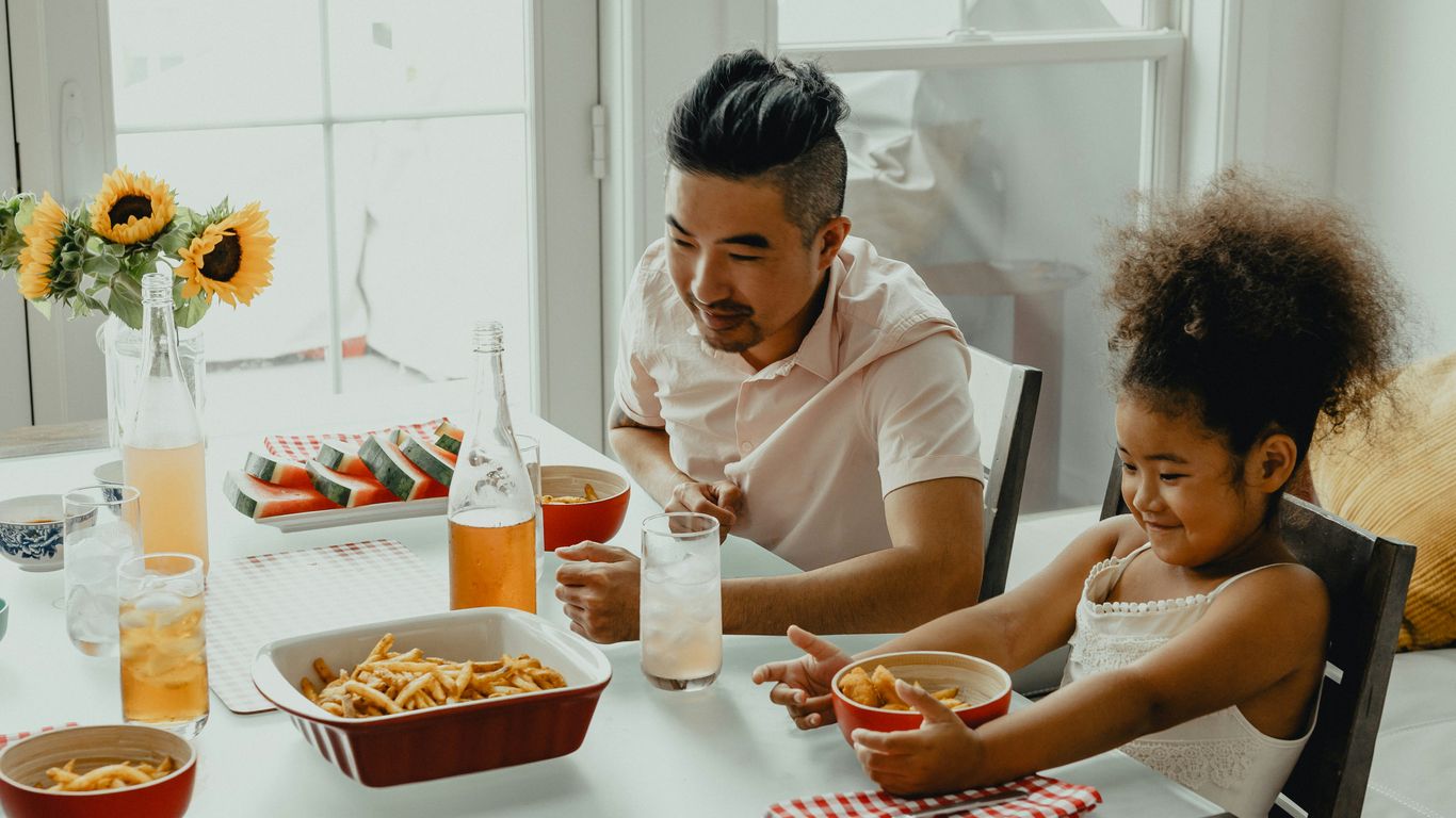 Family gathering around dining table