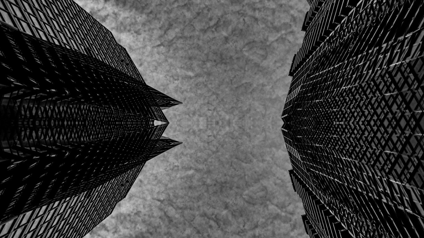 Two skyscrapers viewed from below against sky