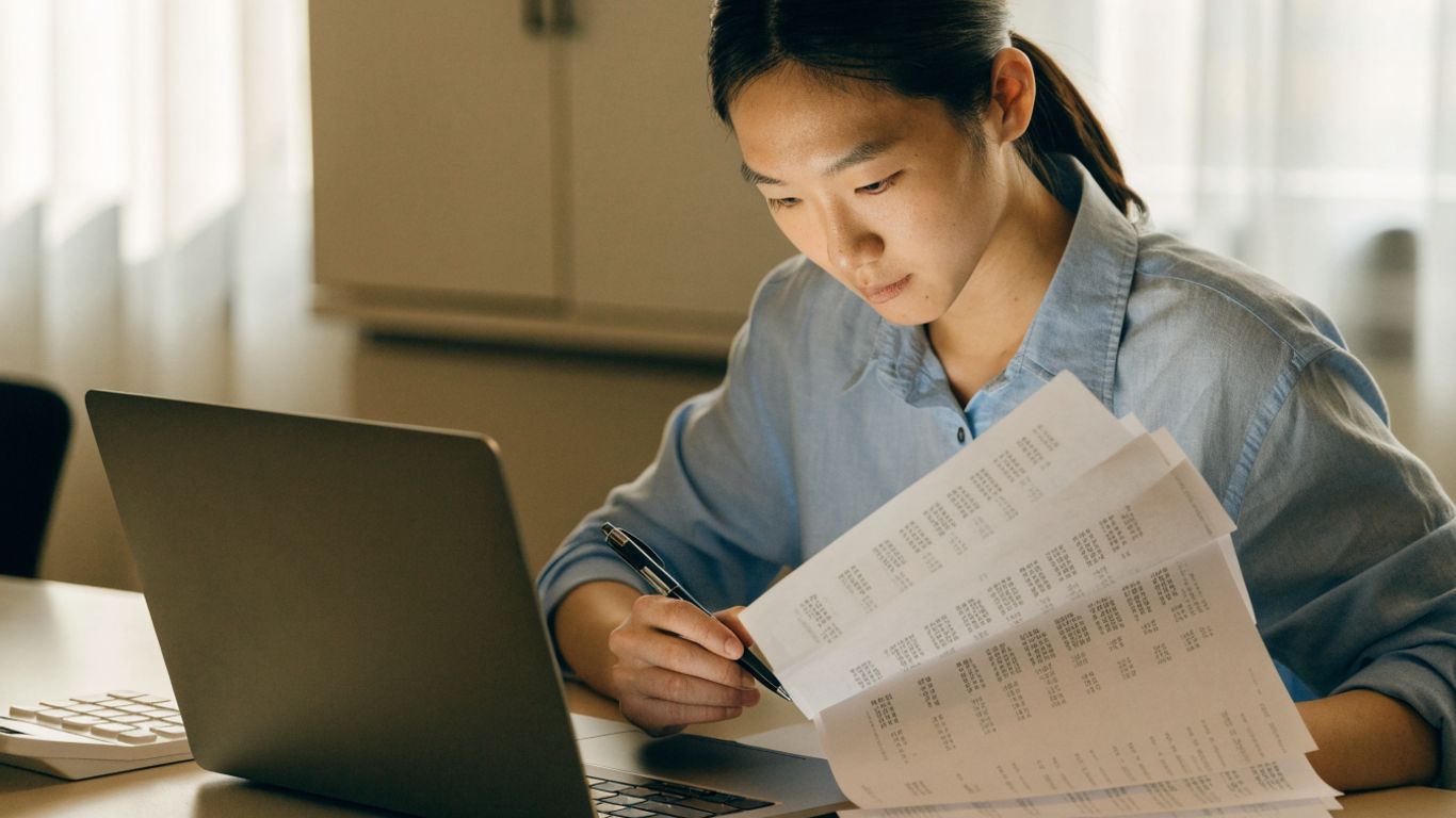 Analyst checking imported statement transactions at desk