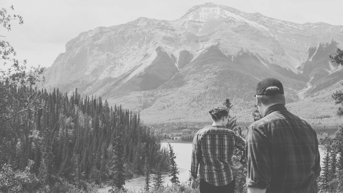 a couple of people that are standing in the grass