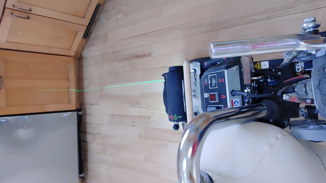 A laser tool on a machine in a kitchen setting.