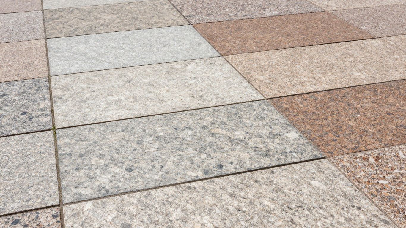 Outdoor patio paved with large, natural granite slabs.