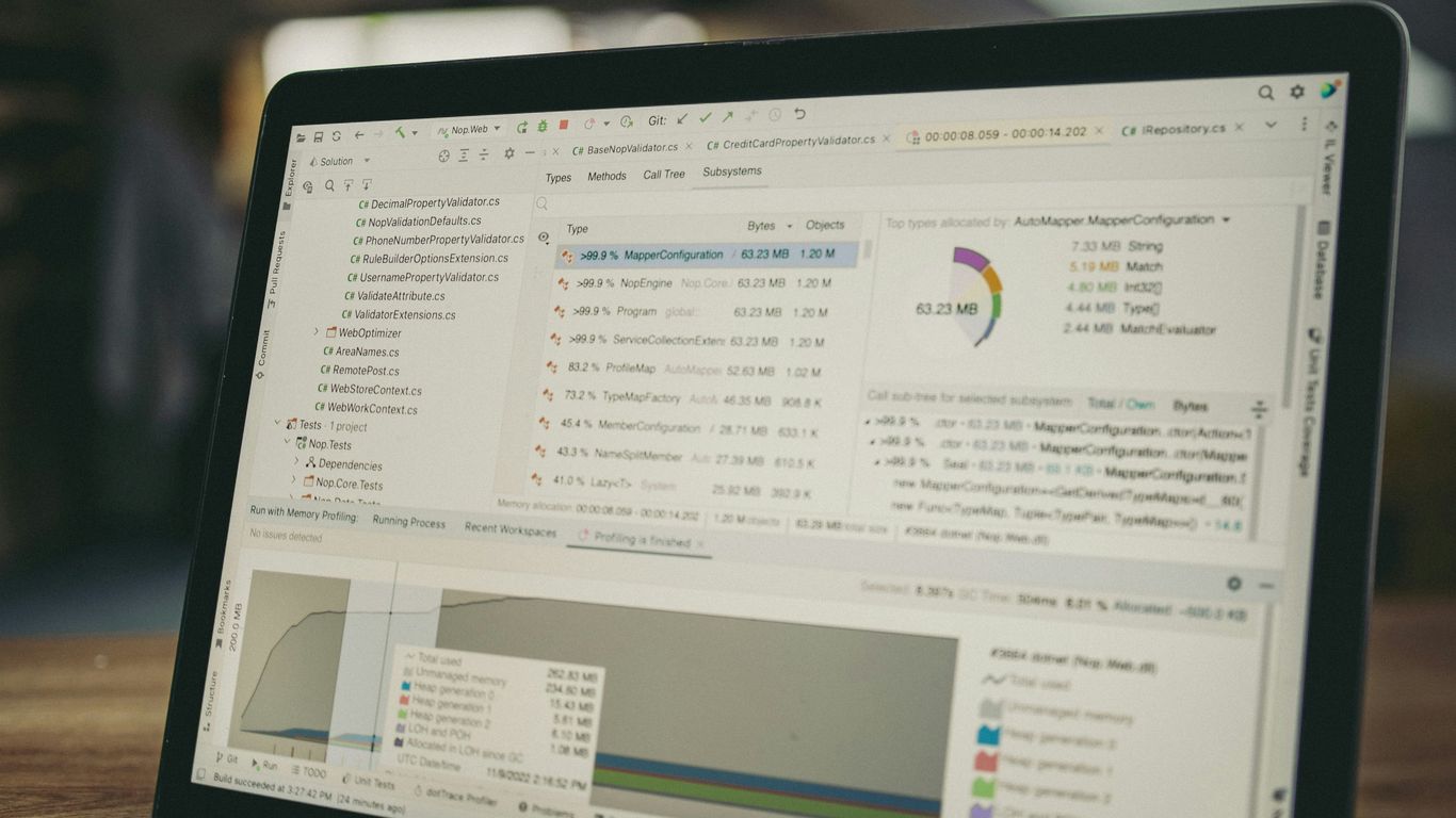 Laptop screen displaying code and data charts.