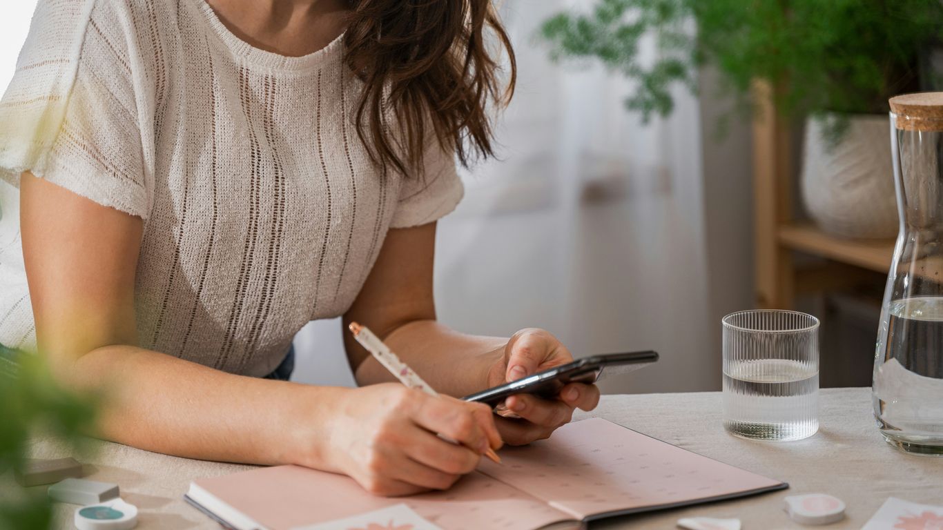 a woman writing on a piece of paper