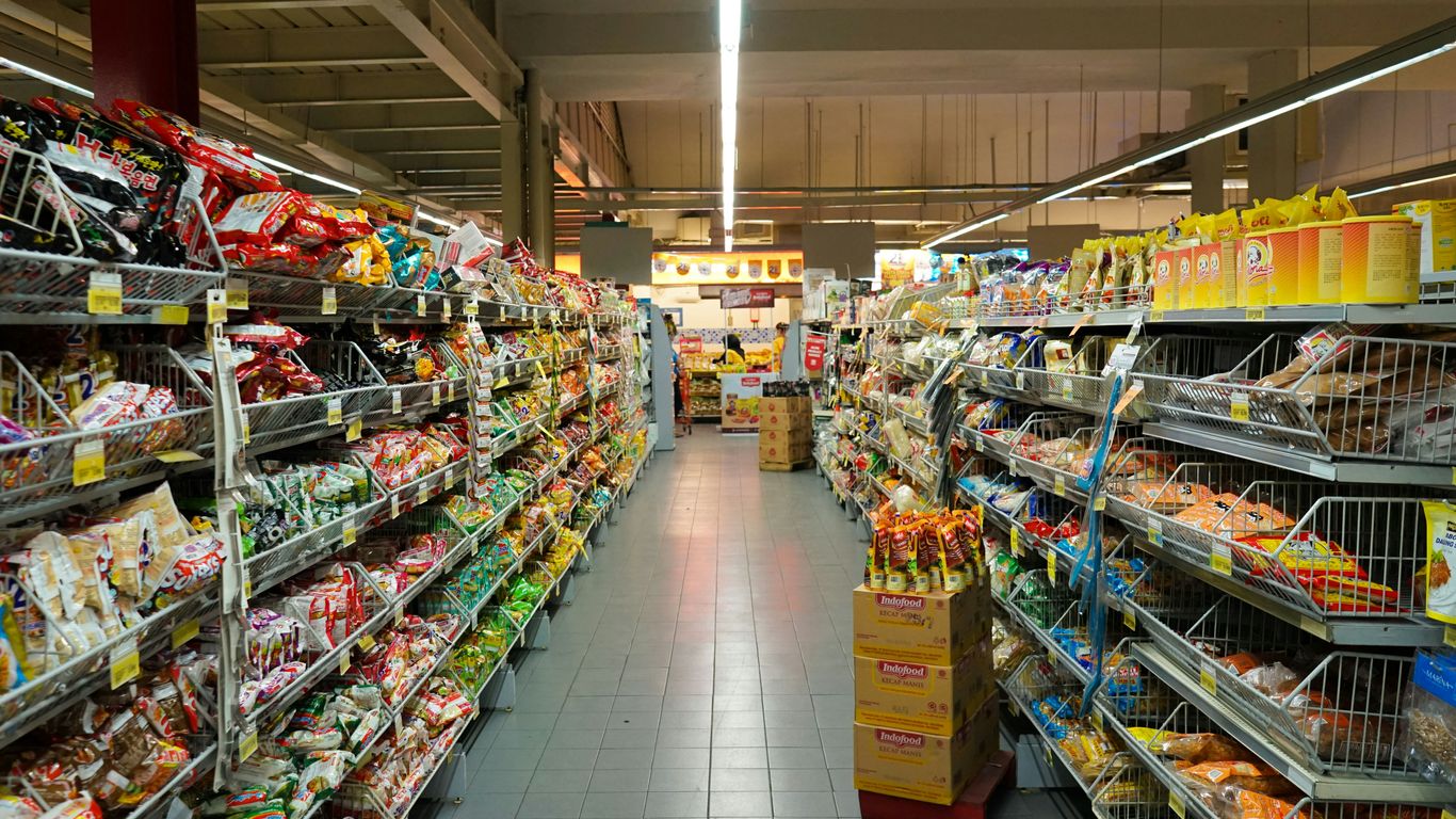 Shoppers moving through the bustling mall aisles