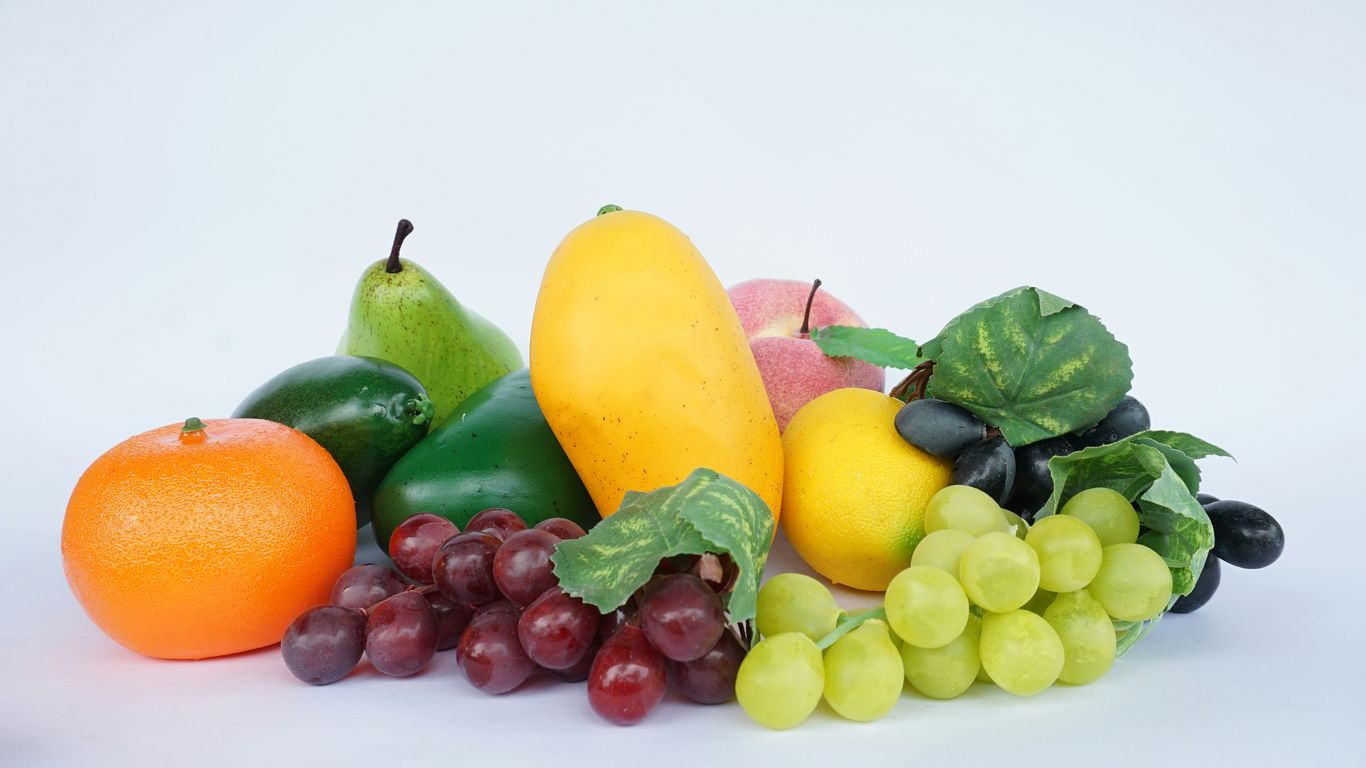 Assorted fresh fruits including grapes, mango, and orange.