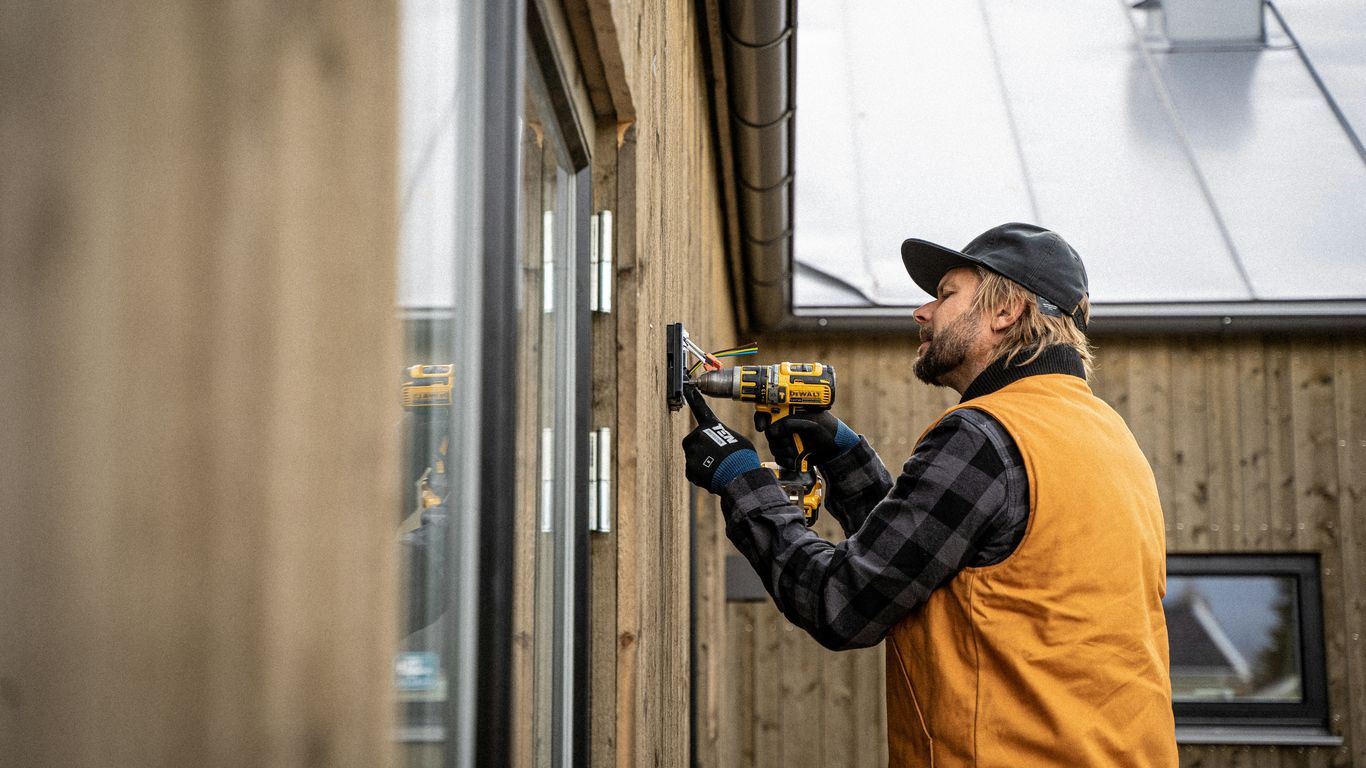 a man with a driller and a hat on