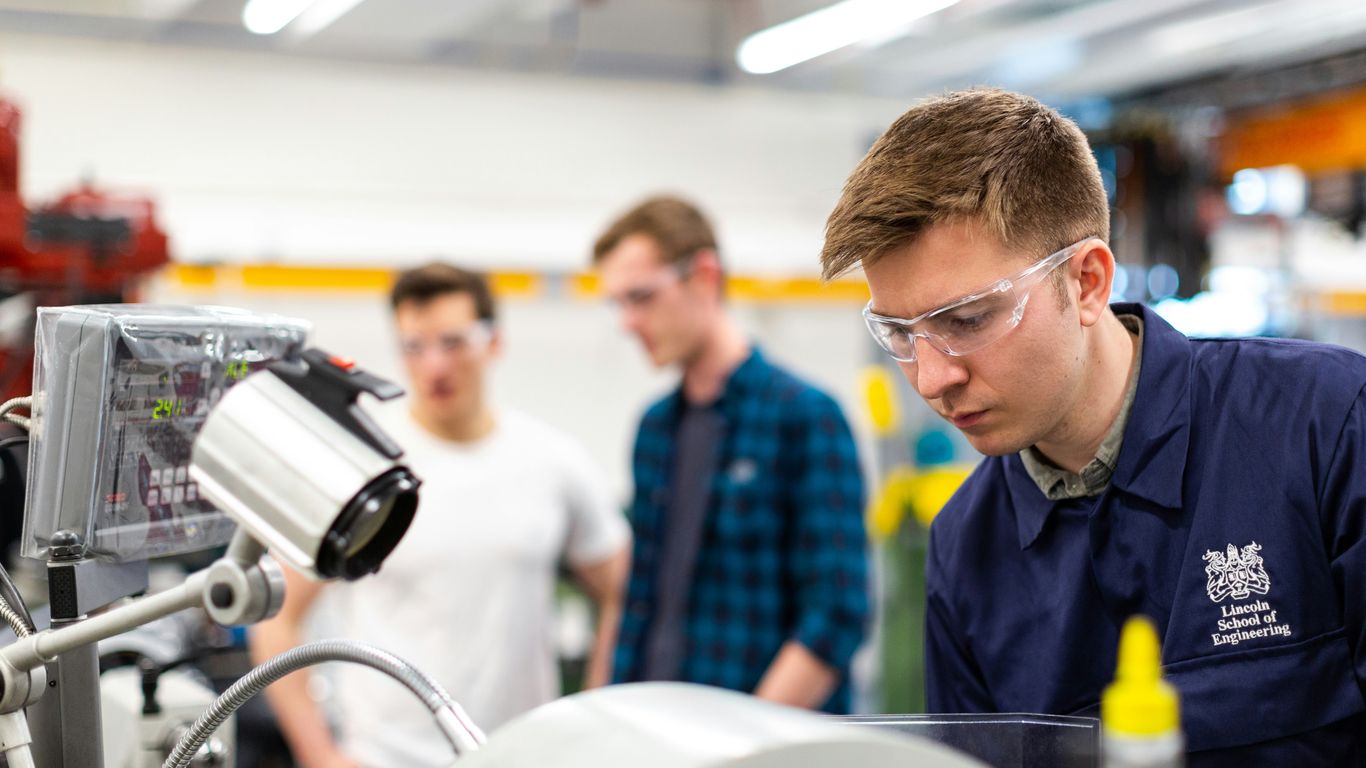 Engineer testing robot software in laboratory