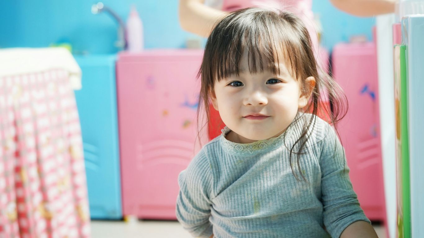 toddler wears blue long-sleeved shirt