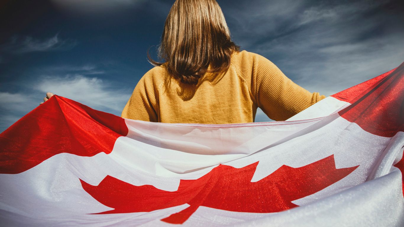 woman holding Canada flag