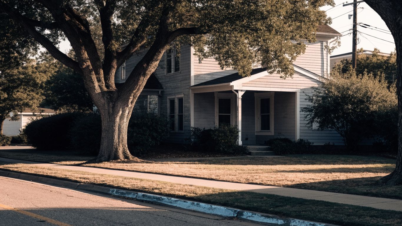 Kingwood home with a shaded yard and welcoming porch