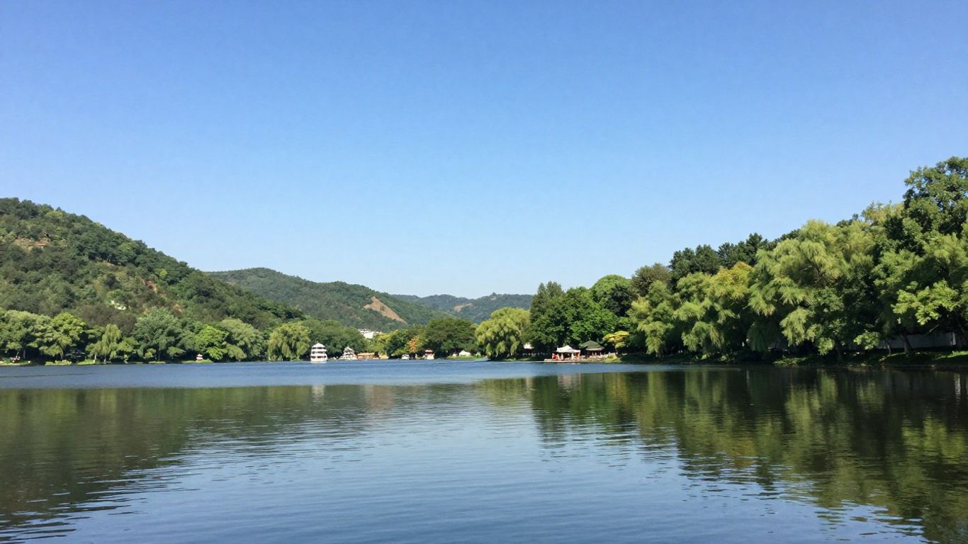 Boats on a calm lake surrounded by green hills.