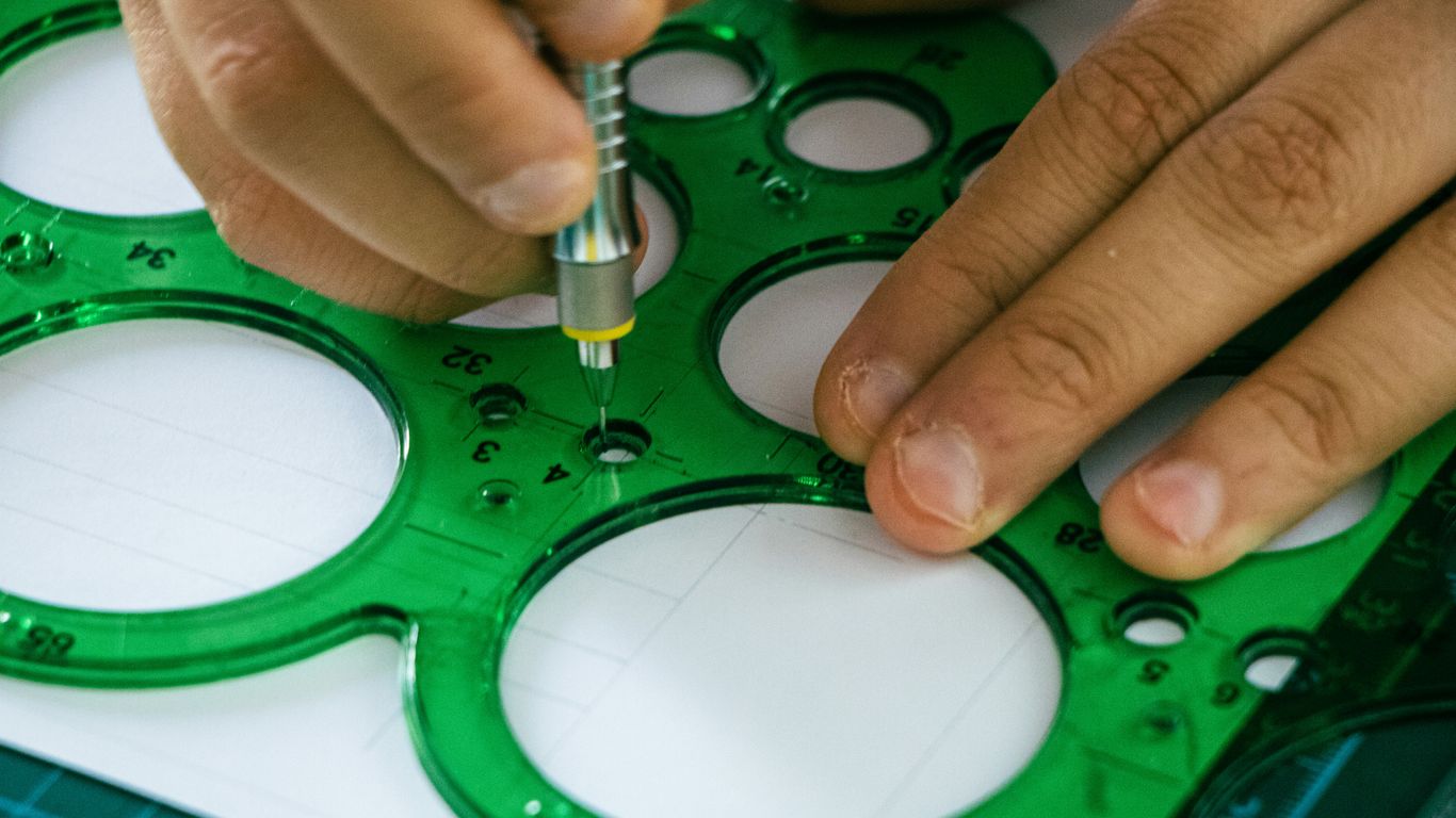 A person is making a hole in a piece of paper