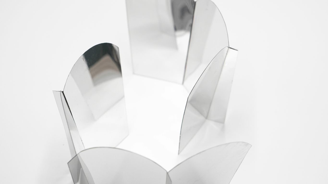 A clear vase with a flower on top of it