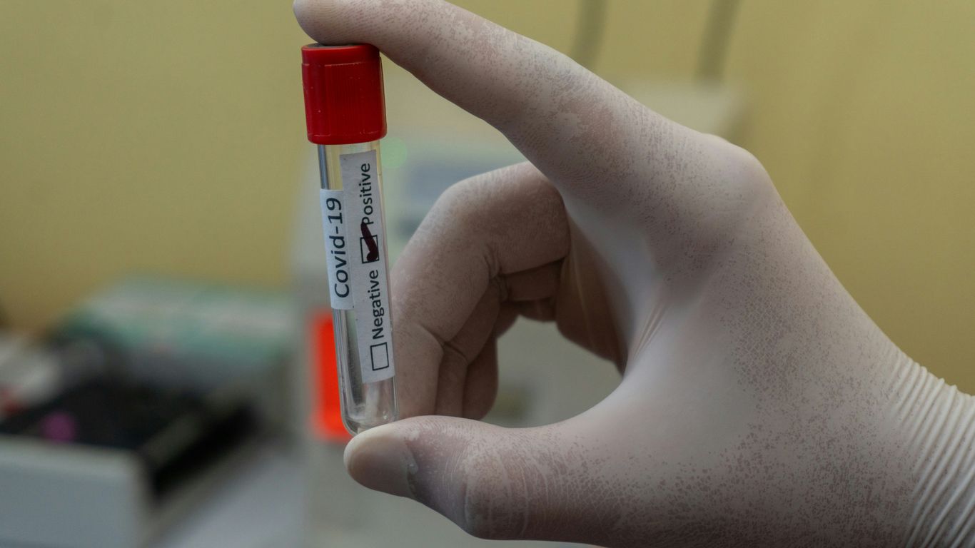 person holding white and red plastic tube